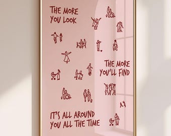 May include: A rectangular wall art print in a thin gold frame featuring a light pink background with dark red line drawings of various people and the text: THE MORE YOU LOOK, THE MORE YOU'LL FIND, IT'S ALL AROUND YOU ALL THE TIME.