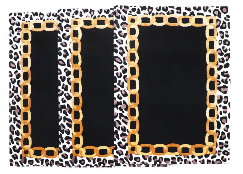 May include: Three rectangular placemats featuring a central solid black panel bordered by a gold-toned chain link graphic. The outer edge of each placemat displays a black, white, and grey leopard print pattern on a white background.