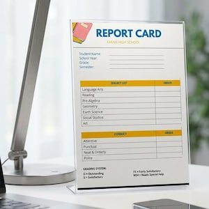 May include: A clear acrylic stand holding a printed report card for Faran High School. The document features sections for student information, a subject list, conduct grades, and a grading system key with O, S, FS, and NSH grade definitions.