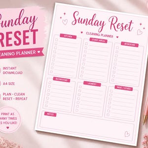 May include: A pink and white A4-sized cleaning planner labelled "Sunday Reset." The planner is divided into sections for kitchen, living areas, bedrooms, bathrooms, laundry, and misc/other. Includes a pink pen and flowers.