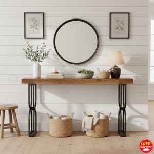 May include: A rustic console table with a light brown wooden top and black metal legs. The table is decorated with a round mirror, framed botanical prints, a lamp, and decorative baskets. A small wooden stool is to the left.