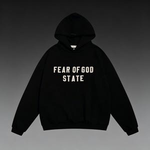 May include: Black hooded sweatshirt with the text "FEAR OF GOD STATE" in white block letters. The sweatshirt has a drawstring hood and a kangaroo pocket. The garment is made of a soft, comfortable material.