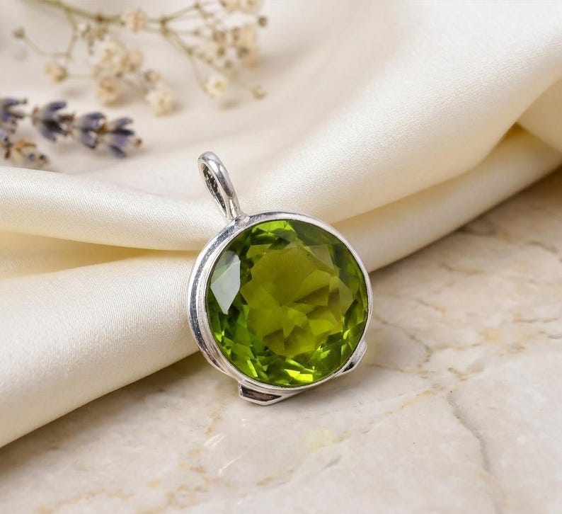 Handmade green peridot pendant crafted in 925 sterling silver.
Natural green peridot gemstone pendant with elegant silver setting.
Sterling silver peridot pendant featuring a vibrant green gemstone.
Handmade peridot jewelry pendant gift for her in 925 silver.
Nature-inspired green peridot pendant with artisan silver craftsmanship.