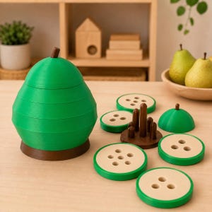 May include: A pear-shaped stacking toy made of green and brown plastic. The toy consists of a base, several circular discs with varying numbers of holes, and a top piece. The discs are green with beige centers, and the central post is brown.
