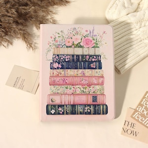 May include: A light pink rectangular notebook cover featuring a vertical stack of seven illustrated books with floral patterns and gold accents, topped with a bouquet of pink roses, lavender, and greenery, with text on the spines.