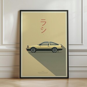 May include: A framed vertical poster featuring a side profile illustration of a two-tone beige and black sports car. The background is a light tan color with red Japanese characters above the car and a dark gray shadow cast beneath it.