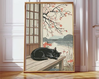 May include: A framed wall art print depicting a black cat sleeping on a wooden porch. The scene features a sliding door, a blooming cherry blossom branch, and a calm lake with distant mountains in the background, rendered in a muted color palette.