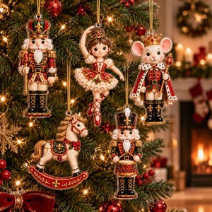 May include: A set of five Christmas tree ornaments featuring a nutcracker soldier, a ballerina in a red dress, a mouse king in a crown and cape, a rocking horse, and a drummer nutcracker, all detailed with gold accents and hanging by gold cords.