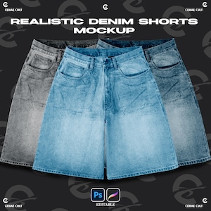 May include: Three pairs of denim shorts in gray, light blue, and medium blue washes, featuring a classic five-pocket design with a button fly and belt loops. The text "REALISTIC DENIM SHORTS MOCKUP" appears at the top, with "Ps" and "EDITABLE" below.