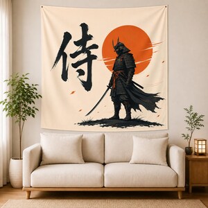 May include: A wall tapestry featuring a black silhouette of a samurai warrior in traditional armor holding a katana. The design includes a large orange sun, scattered petals, and the black Japanese kanji character for samurai on a cream background.