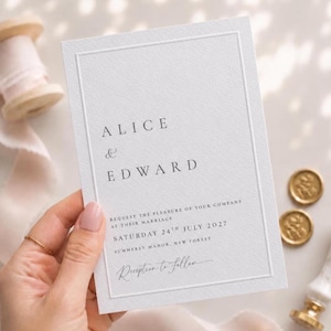 May include: A white rectangular wedding invitation card with a debossed border frame. The text reads ALICE & EDWARD, REQUEST THE PLEASURE OF YOUR COMPANY AT THEIR MARRIAGE, SATURDAY 24TH JULY 2027, SUMMERLY MANOR, NEW FOREST, Reception to follow.