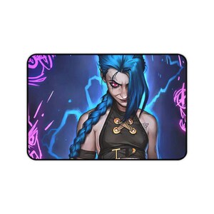 May include: A rectangular desk mat featuring a digital illustration of a character with long blue braided hair and pink eyes. The character wears a black halter top with gold eyelet details against a dark blue background with neon pink graffiti.