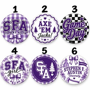 May include: Six circular pin-back buttons featuring purple and white designs. Designs include text such as SFA, Stephen F. Austin, Axe 'Em Jacks, and Game Day, alongside graphics of bows, checkered patterns, floral motifs, pine trees, and an axe.
