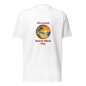 May include: White t-shirt featuring a colorful beach scene with palm trees, ocean, and sunset within a circular design. Text reads "4th annual Beach Ditch Day" in red. A casual, short-sleeved tee.