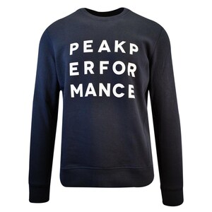 May include: A dark navy blue long-sleeve sweatshirt featuring a crew neckline and ribbed cuffs. The front of the garment displays the white text PEAK PERFORMANCE arranged in three stacked lines across the centre of the chest area.