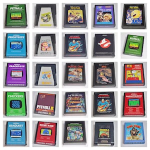 May include: A collection of Atari video game cartridges, each in its original case. The games include titles like "Pitfall!", "Frostbite", "Crackpots", "Checkers", "Seaquest", "Tank Plus", "Pac-Man", "Amidar", "Dodger Cars", and "River Raid".