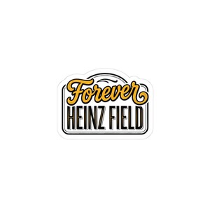 May include: A white sticker with the words "Forever HEINZ FIELD" in a black and gold design. The word "Forever" is in a stylized gold script, and "HEINZ FIELD" is in a bold, black font.