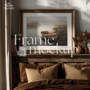 May include: A framed artwork featuring a boat on a misty lake. The frame is gold, and the artwork is displayed above a bed with brown pillows and bedding. The image includes the text "Frame mockup" and a PSD file icon.