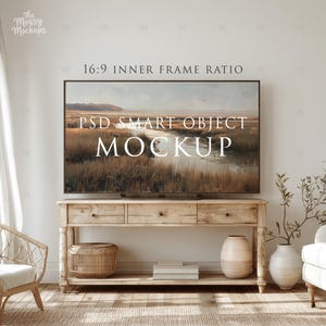May include: A large flat-screen television displaying a landscape painting, mounted above a light wood console table. The text "16:9 INNER FRAME RATIO" and "PSD SMART OBJECT MOCKUP" are visible. The room has a neutral color palette with a woven rug and decorative vases.