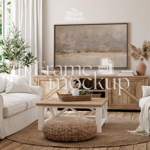 May include: A living room scene with a neutral color palette. Features a large abstract painting above a wooden cabinet. A white sofa, coffee table, and woven rug complete the space. Decorative elements include a vase with dried flowers and a woven basket.