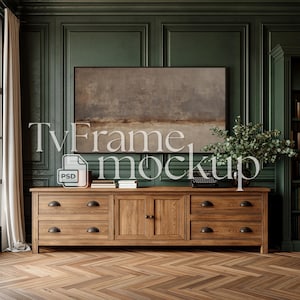 May include: A wooden TV stand with drawers and doors, holding books, a typewriter, and a vase of greenery. A framed artwork hangs above the stand, against a dark green paneled wall. The text "TvFrame mockup" is displayed on the image.