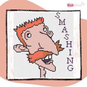 May include: Cross-stitch pattern featuring a cartoon character with orange hair and a large nose. The word "SMASHING" is vertically displayed in purple letters. The design is on a white background with a pink border. The BlobStitch logo is in the top right corner.
