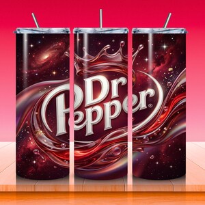 May include: Three stainless steel tumblers with a Dr Pepper design. The design features the Dr Pepper logo in white, surrounded by a swirling red and brown liquid against a cosmic background. Each tumbler has a silver lid and a straw.