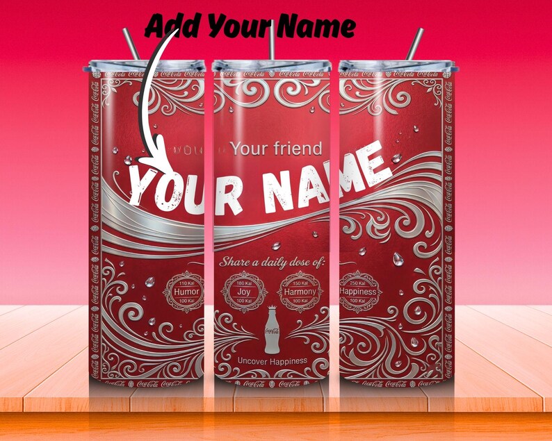 May include: Red and silver personalized tumbler with the text "YOUR NAME" in white. The tumbler features a Coca-Cola design with decorative swirls and the phrase "Share a daily dose of: Humor, Joy, Harmony, Happiness."