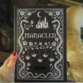 Manacled Illustrated Collector’s Hardcover Book, Complete Edition with Art Prints and Bookmark product logo