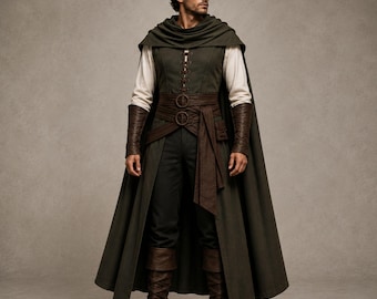 May include: A dark olive green hooded cloak worn over a cream-colored long-sleeve shirt and a dark green vest with front lacing. The outfit includes a wide brown belt with two circular buckles, dark brown leather bracers, and dark brown boots.