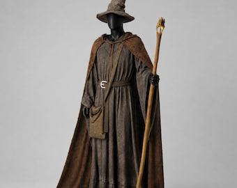 May include: A brown wizard costume featuring a long-sleeved robe, a matching hooded cloak, and a pointed hat. The outfit includes a brown belt with a silver buckle, a shoulder-slung satchel, and a tall wooden staff topped with a gold-colored ornament.