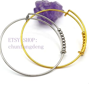 May include: Two adjustable bangle bracelets. One is silver, the other is gold. The silver bracelet has a row of small, round beads. The gold bracelet has a few small, round beads. The text "ETSY SHOP: chunfangdeng" is visible.