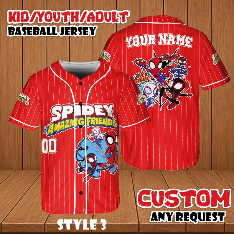 May include: Red baseball jersey with white pinstripes, featuring the text "SPIDEY AMAZING FRIENDS" and the number "00". The back of the jersey has a "YOUR NAME" section and a graphic of Spider-Man characters. The jersey is labeled "STYLE 3".