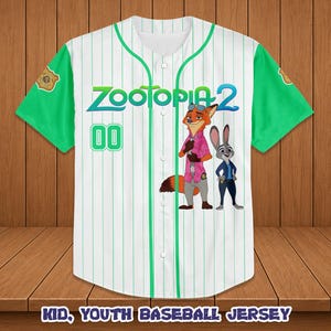 May include: White baseball jersey with green sleeves and pinstripes. Features the text "Zootopia 2" and cartoon characters Nick Wilde and Judy Hopps. Includes the number "00" on the front. The jersey is labeled "Kid, Youth Baseball Jersey".