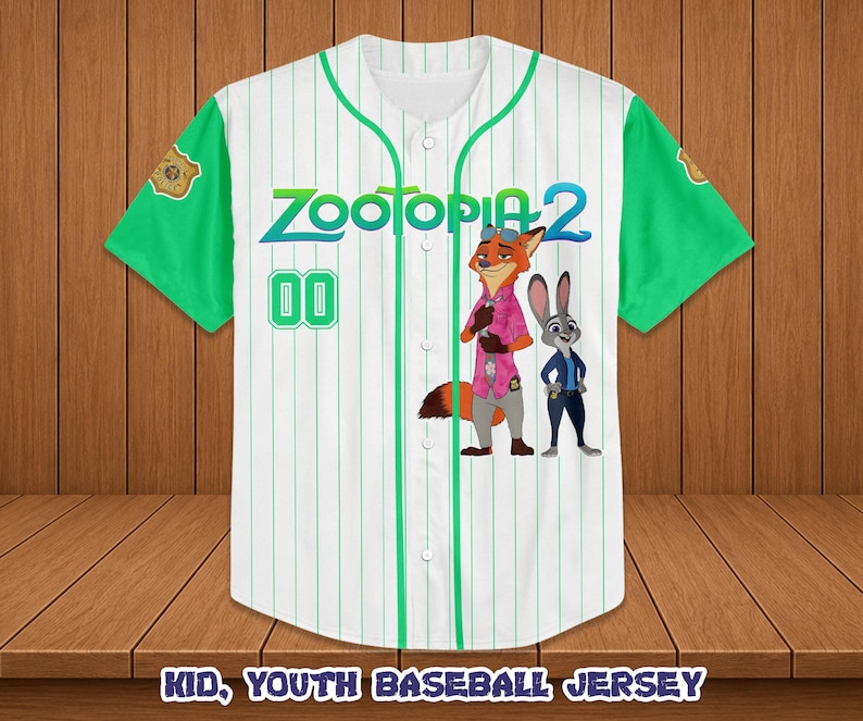 May include: White baseball jersey with green sleeves and pinstripes. Features the text "Zootopia 2" and cartoon characters Nick Wilde and Judy Hopps. Includes the number "00" on the front. The jersey is labeled "Kid, Youth Baseball Jersey".