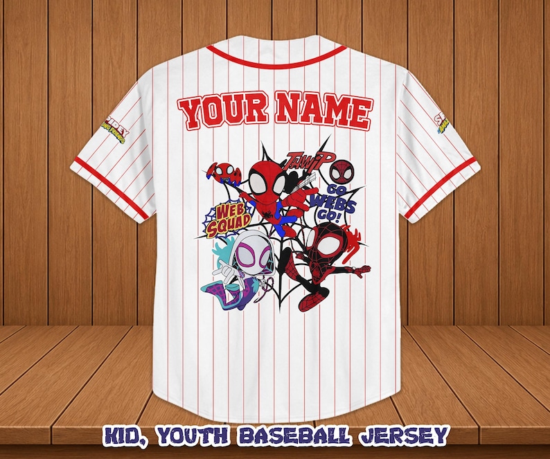 May include: White baseball jersey with red pinstripes, featuring a colorful Spider-Man graphic on the back. The jersey has red trim and the text "YOUR NAME" above the graphic. The bottom of the jersey reads "KID, YOUTH BASEBALL JERSEY".
