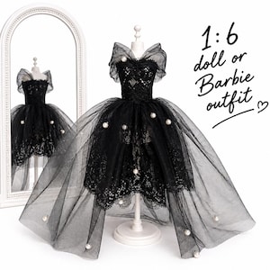 May include: A black doll outfit with a lace bodice and a layered tulle skirt, adorned with faux pearls. The outfit is displayed on a white mannequin, with a matching reflection in a nearby mirror. Text on the image reads "1:6 doll or Barbie outfit".