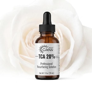 May include: An amber glass dropper bottle with a black cap, featuring a white label that reads iFeel Glow TCA 20% Professional Resurfacing Solution Net Wt 1 fl oz (30 mL), positioned in front of a large, soft-focus white rose blossom.