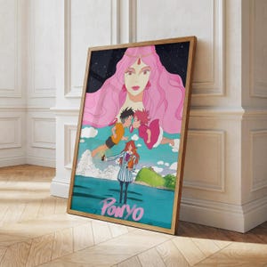 May include: A framed art print featuring a colorful illustration from the animated film "Ponyo." The artwork depicts a large pink-haired figure, two children, and a girl in a striped outfit. The title "Ponyo" is written in teal at the bottom.