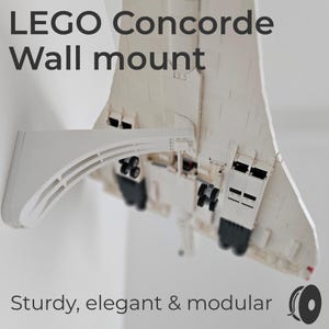 May include: A white LEGO Concorde model mounted on a white wall mount. The text "LEGO Concorde Wall mount" is at the top, and "Sturdy, elegant & modular" is at the bottom. The model has black wheels and is angled downward.