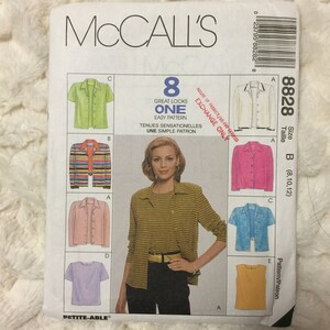 May include: A McCall's sewing pattern featuring illustrations of eight different shirt and jacket styles. The pattern includes a woman wearing a striped shirt and black pants. The pattern number is 8828.