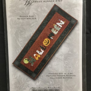 May include: A Halloween runner pattern with the text "Happy Halloween" and "Halloween Runner #747". The runner features a design with Halloween-themed accents and buttons. Finished size is 14" x 34".