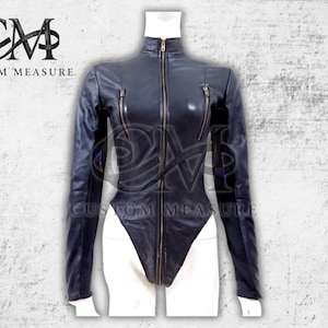 May include: A black leather bodysuit with a high collar and long sleeves. The garment features a full-length zipper and two small zippered pockets on the chest. The brand name "CUSTOM MEASURE" is visible in the upper left corner.