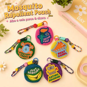 May include: Five circular mesh pouches with colorful embroidered patches and wrist straps. The patches feature characters and text: Artsy Fart, Control Freak, Keep Going, Just Hanging with a banana, and Eating Machine with a robot graphic.