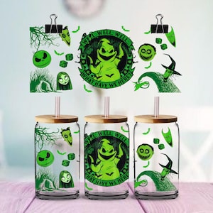 May include: Three clear glass tumblers with bamboo lids and straws, featuring green graphic prints of characters and motifs from The Nightmare Before Christmas, including Oogie Boogie with the text Well, Well, Well... What Have We Here?