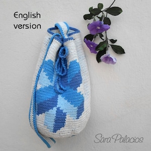 May include: A white crocheted bag with a blue floral design. The bag has a drawstring closure and is made with a textured yarn.