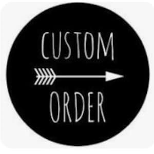 May include: A circular black sign featuring the white text CUSTOM ORDER in a thin, sans-serif font. A white horizontal arrow with a feathered tail and a pointed tip is positioned between the two words, pointing toward the right side.