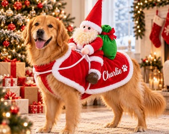 May include: A golden retriever wearing a red and white velvet pet costume featuring a plush Santa Claus figure riding on its back. The costume includes a green sack, white trim, and the name Charlie printed in white script next to a paw print icon.