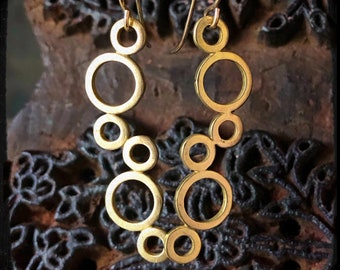 May include: Gold tone earrings with a cascading design of interlocking circles.