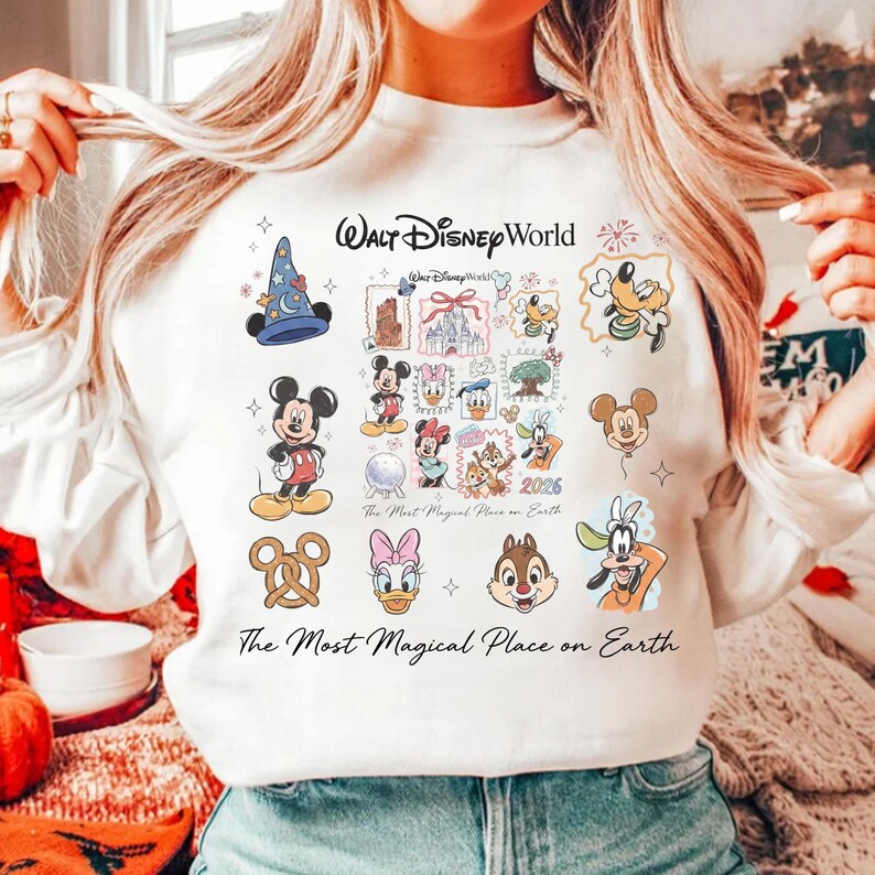 High-quality print detail on a white top featuring the castle, Mickey ears, and nostalgic Disney world typography.